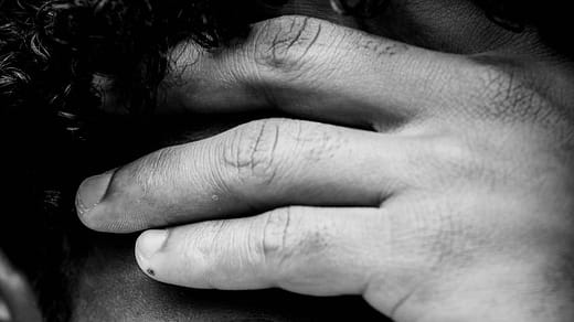 man holding his face